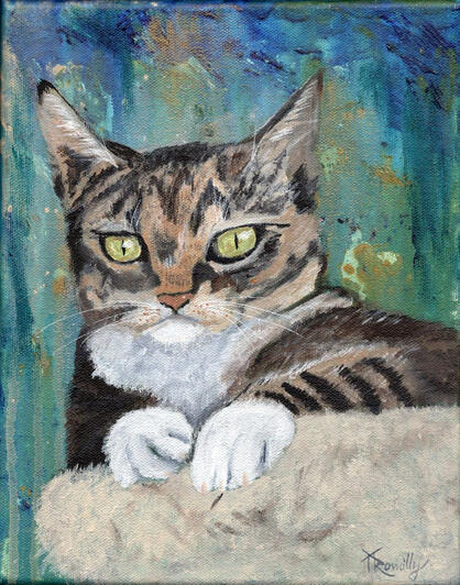 Closeup of a tabby cat with white paws sitting atop her perch observing what's going on below her.