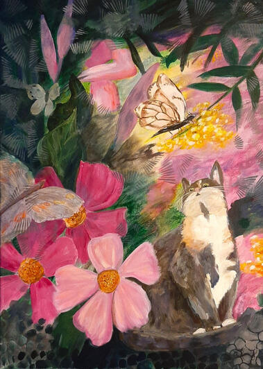 A dilute calico cat sits among camellia blooms and looks up to watch the butterflies